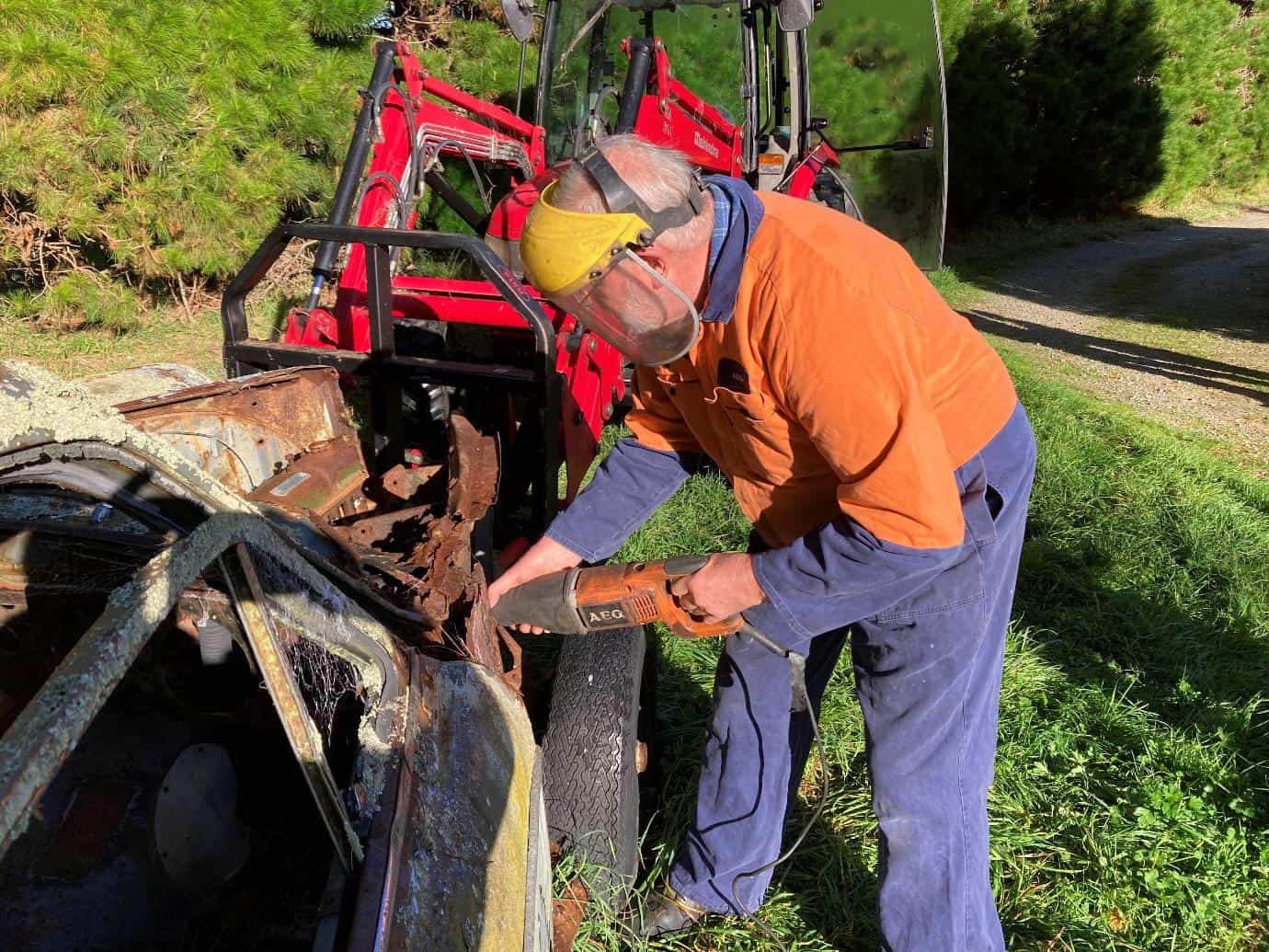 Hugh Mackenzie at Porirua sawing off the front of the 690 Wolseley Car Club NZ