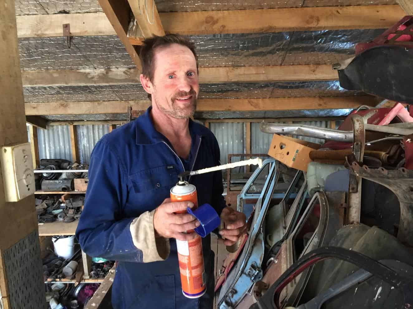 Rod Baxter blocking up the bird access with expanding foam Wolseley Car Club NZ